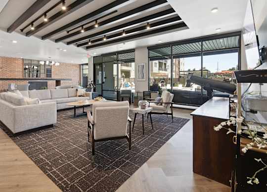 A modern living room with a brick wall and a large window.