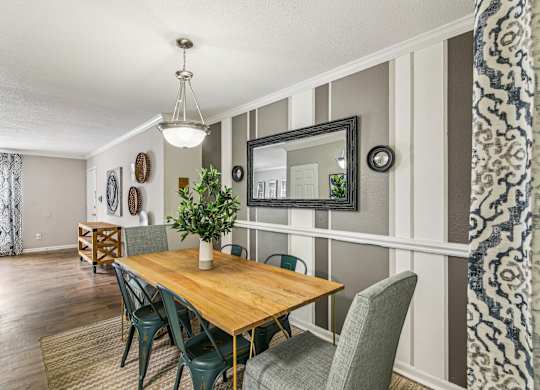 A dining room with a wooden table and chairs.