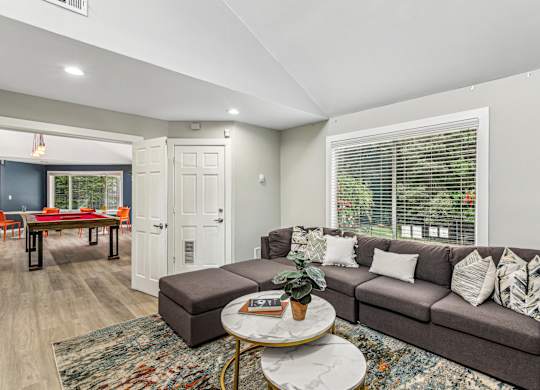 A living room with a grey couch and a coffee table.