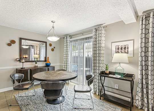A living room with a round table and chairs.