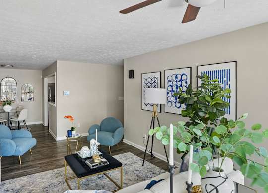 A living room with a blue chair and a black coffee table.