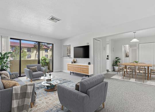 A living room with grey couches and a wooden entertainment center.