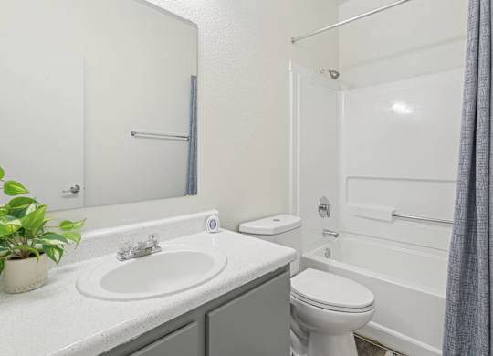 Pet-Friendly Apartments in Austin, TX – Huntington Meadows – A white bathroom with a sink, toilet, and bathtub.