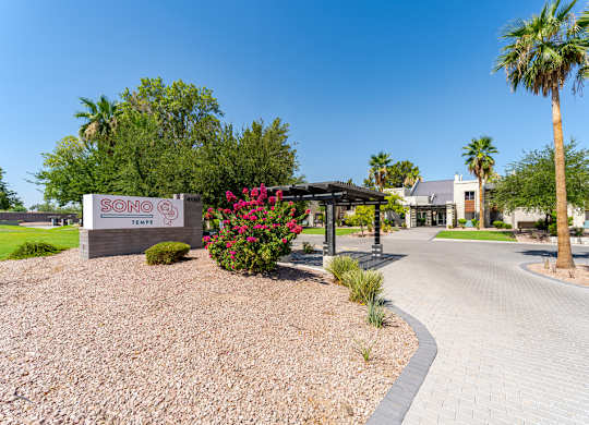 Landscaped entrance to Sono Tempe Apartments in Tempe, AZ with desert-inspired greenery and walkable community paths.