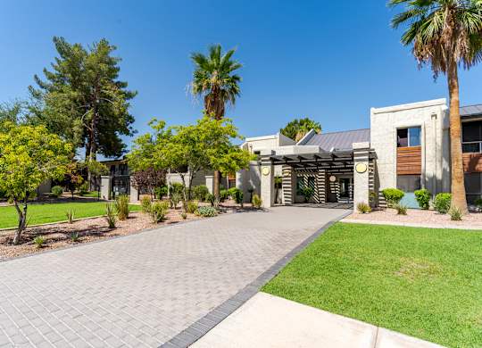 Landscaped entrance to Sono Tempe Apartments in Tempe, AZ with desert-inspired greenery and walkable community paths.