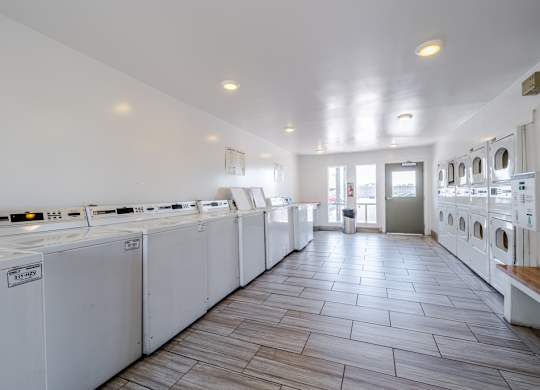 On-site laundry facilities at Sono Tempe Apartments in Tempe, AZ with multiple washers and dryers for resident convenience.