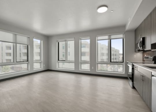 an empty living room with a large window