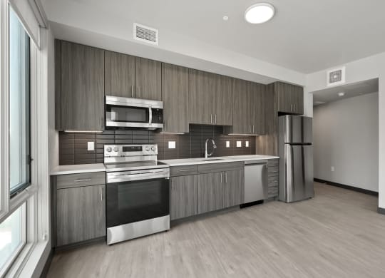 a kitchen with wooden cabinets and stainless steel appliances