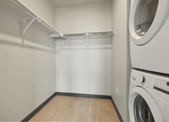 an empty laundry room with a washer and dryer