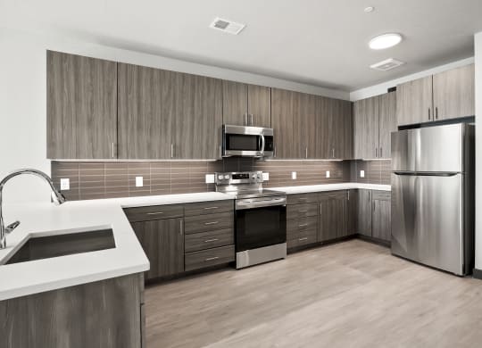 a kitchen with wooden cabinets and stainless steel appliances