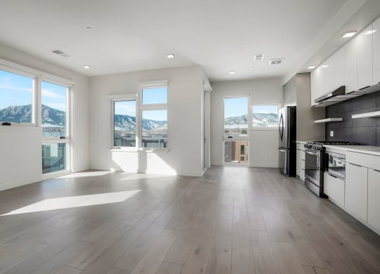 a kitchen with a stove top oven next to a window