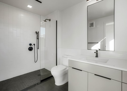 a bathroom with a toilet sink and shower