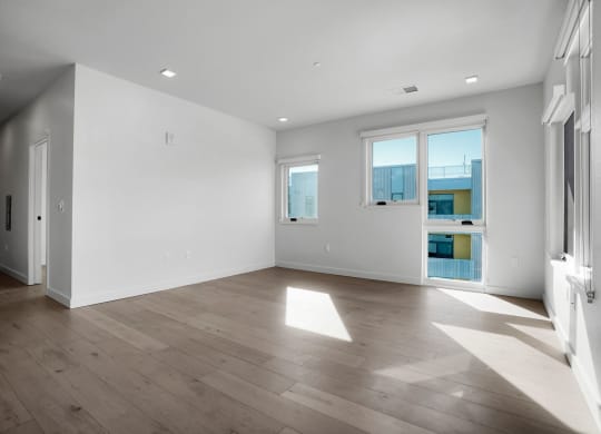 a bedroom with hardwood floors and white walls