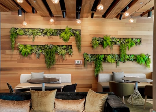 a room with wooden walls and plants on the wall
