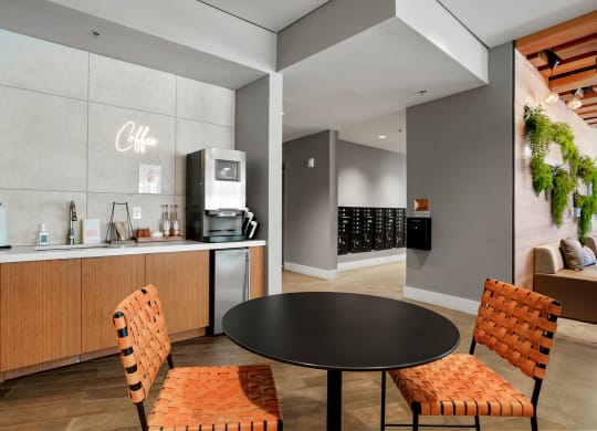 a dining area with a round table and two chairs