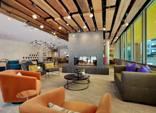 a lobby with couches chairs and a fireplace