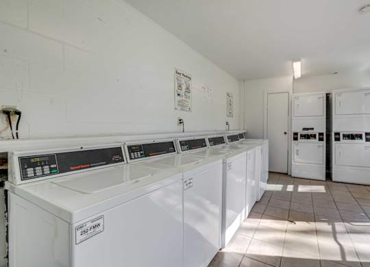 Laundry room with washers and dryers at Square One Apartments in Gainesville FL