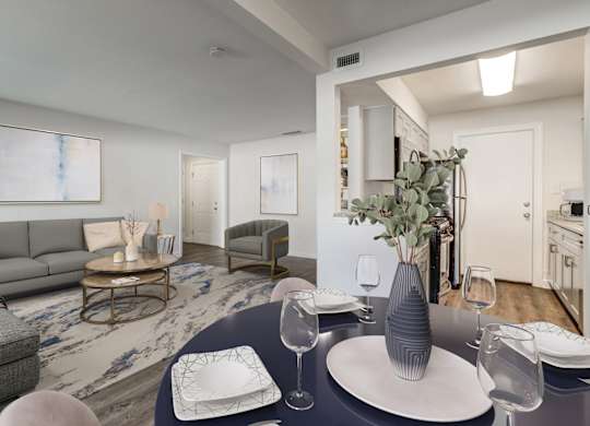 Open dining area next to the living room with wood-style vinyl flooring at Square One Apartments in Gainesville FL