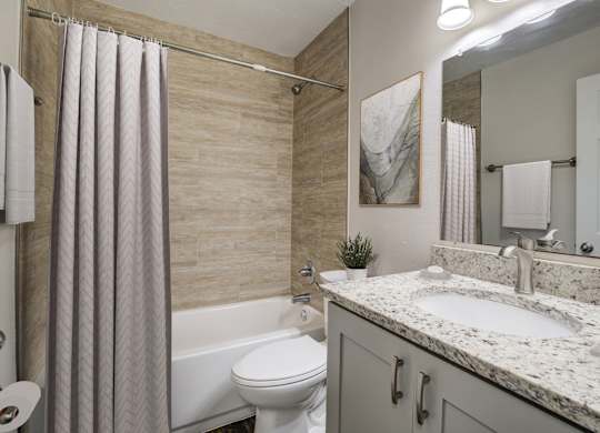 Upgraded bathroom with shower and tub at Square One Apartments in Gainesville FL