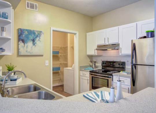 Modern kitchen with stainless steel appliances at Grande Club apartments in Duluth, GA 30096, near Lawrenceville.