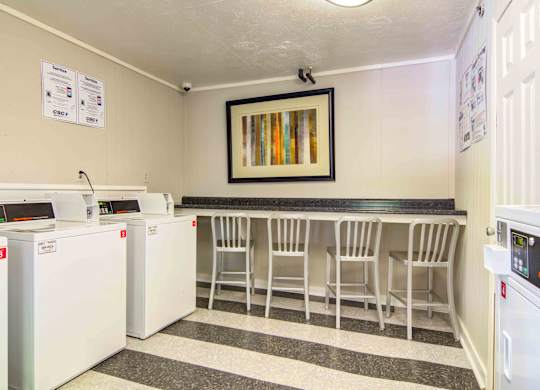 On-site laundry facilities with multiple washers and dryers at Stratford Ridge Apartments in Marietta, GA—offering convenient access for residents without in-unit laundry.