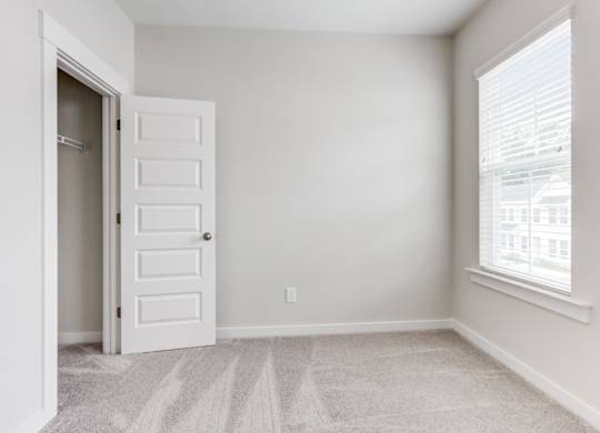 Dog Friendly Townhomes in Park Circle SC - Sumner Village - Well Lit Bedroom with Carpet Flooring, Large Closet, and a Window
