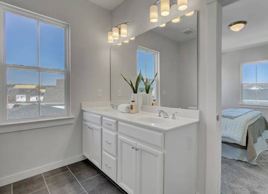 Houses For Rent In North Charleston, SC - Sumner Village - Bathroom With Double Sink, Large Window, And Tile Flooring With Access To Bedroom
