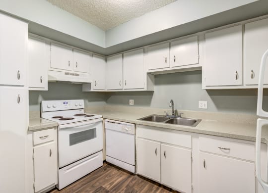 The Commons Apartments in Tampa Florida photo of a kitchen with white cabinets and white appliances