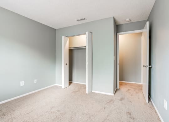 The commons apartments in Tampa Florida photo of a bedroom with an open door and carpeted flooring