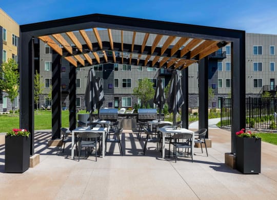 a patio with tables and chairs and awning