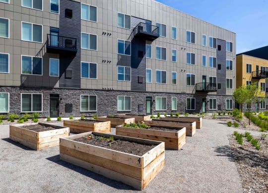 a community garden in front of an apartment building