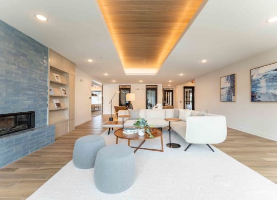 a living room with white furniture and a fireplace