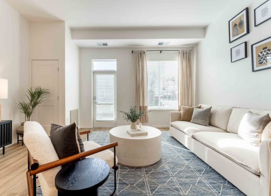 a living room with white couches and a coffee table