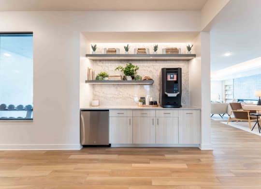 a kitchen with white cabinets and a coffee machine
