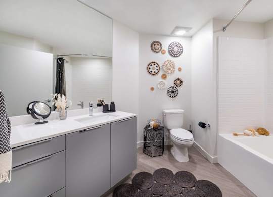 A bathroom with a white tub and a toilet.