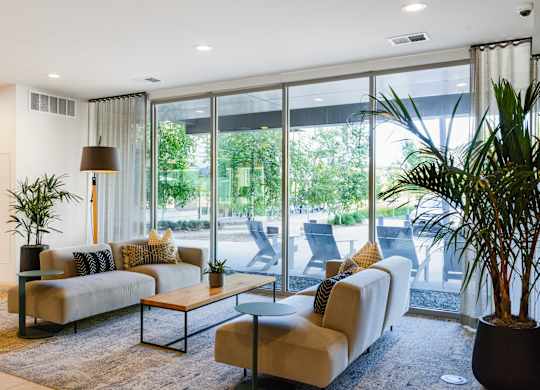 A living room with a large window and a couch.