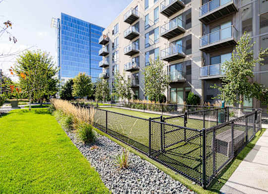 A modern building with a green lawn in front.