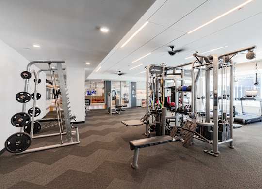 A well-equipped gym with a variety of machines and weightlifting equipment.