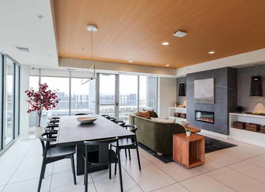 A modern dining room with a wooden table and chairs.