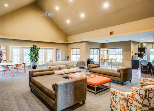 a large living room with couches and chairs