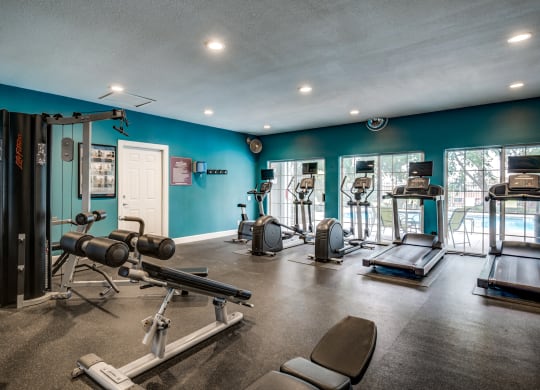 Apartment gym with exercise equipment and a large window