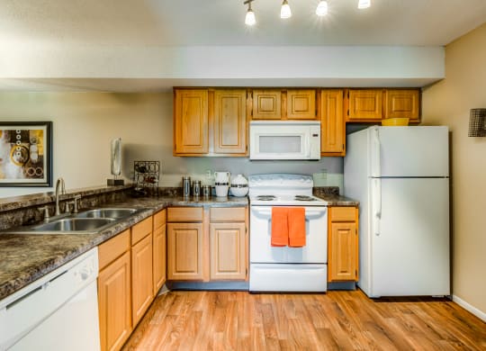a kitchen with white appliances and wooden cabinets