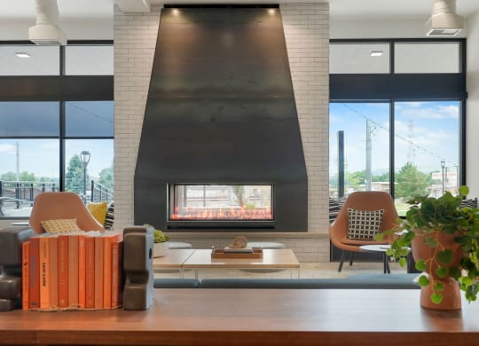 a living room with a fireplace and a large window