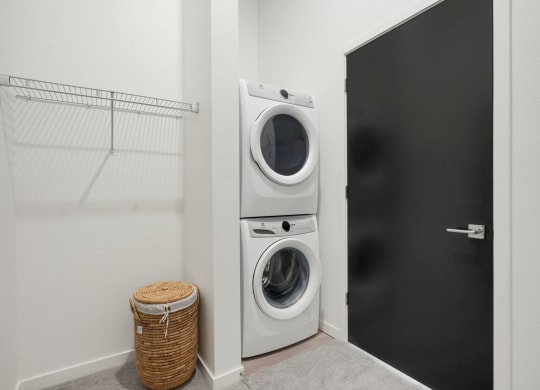 walk in closet with full size washer and dryer