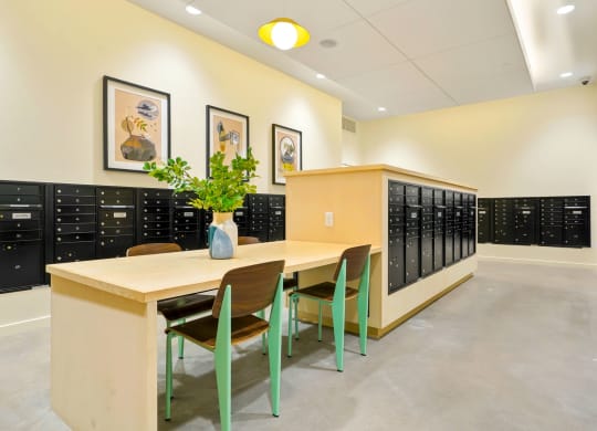 a room with a table and chairs in front of a row of lockers
