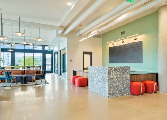 a reception area with a desk and chairs and a large window