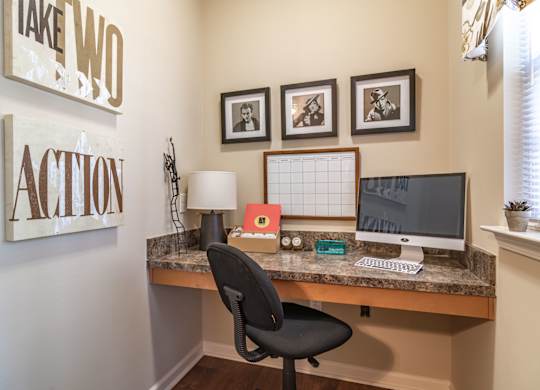 a home office with a desk and computer