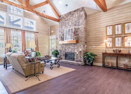 Opelika, AL Apartments – The Crossings of Opelika - clubhouse with high ceilings, seating area and fireplace