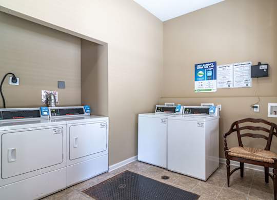 Pet-Friendly Apartments in Opelika, AL – The Crossings of Opelika - a laundry room with washers and dryers