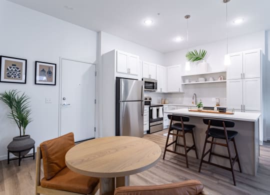 a kitchen with an island and a table